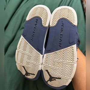 Size 2Y navy blue Jordan’s.  Used and has natural wear and tear which is shown